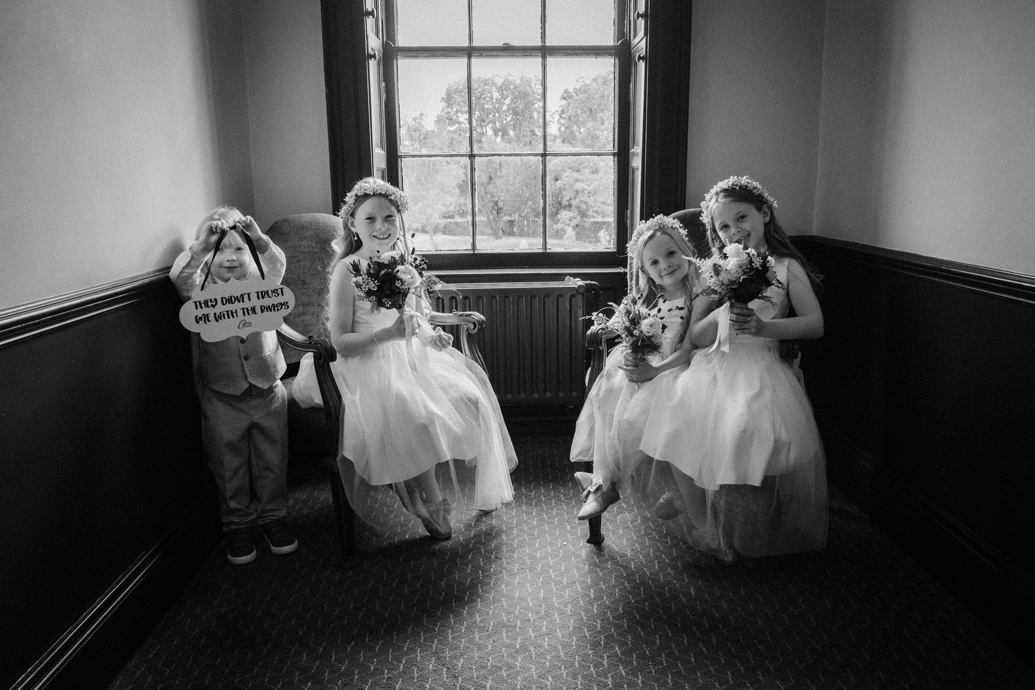 Black and white panoramic series of wedding moments in a sunlit room with windows.