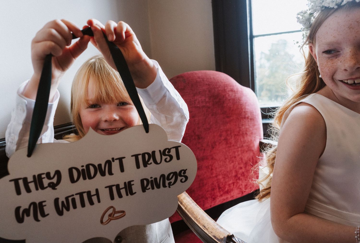 A series of photo booth style images showing playful expressions and poses with handwritten signs.