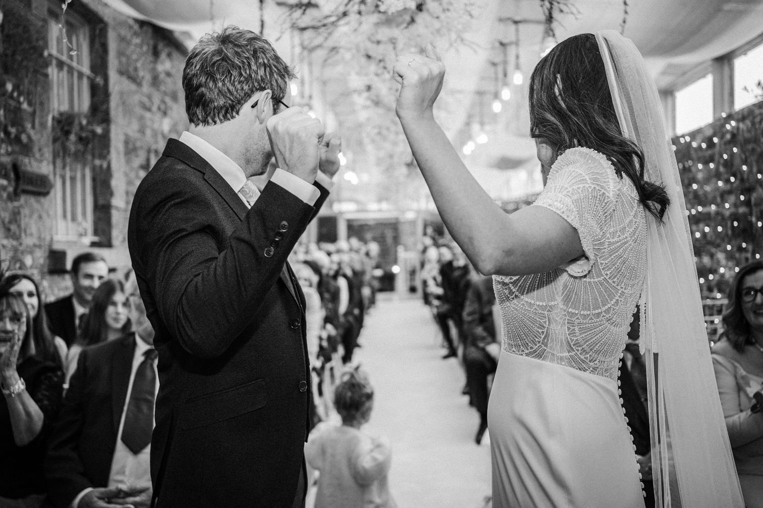 Candid moments captured during a wedding celebration with guests in formal attire.