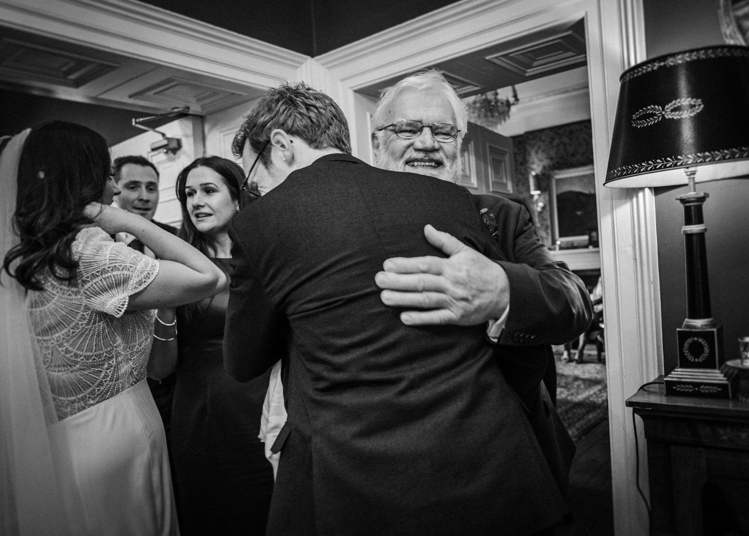 Black and white panorama of wedding reception dancing and celebrations.