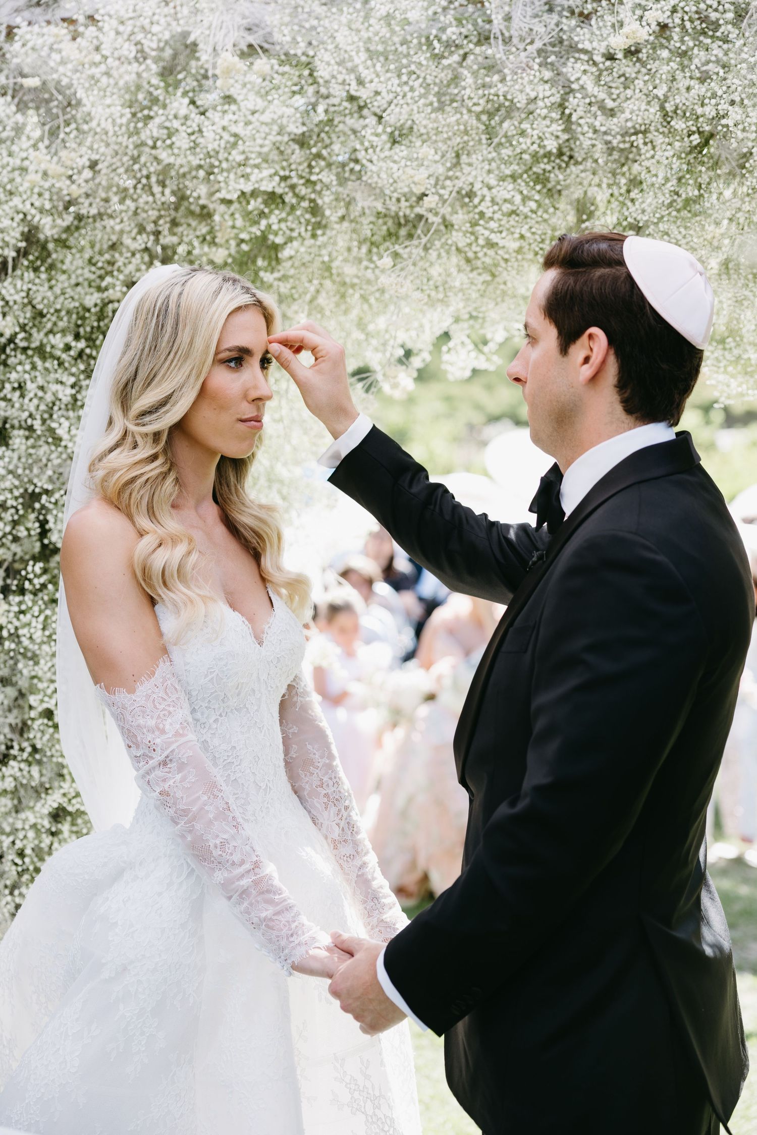 A sequence of wedding photos shows a couple dancing together in a garden setting with white blossoms in the background.