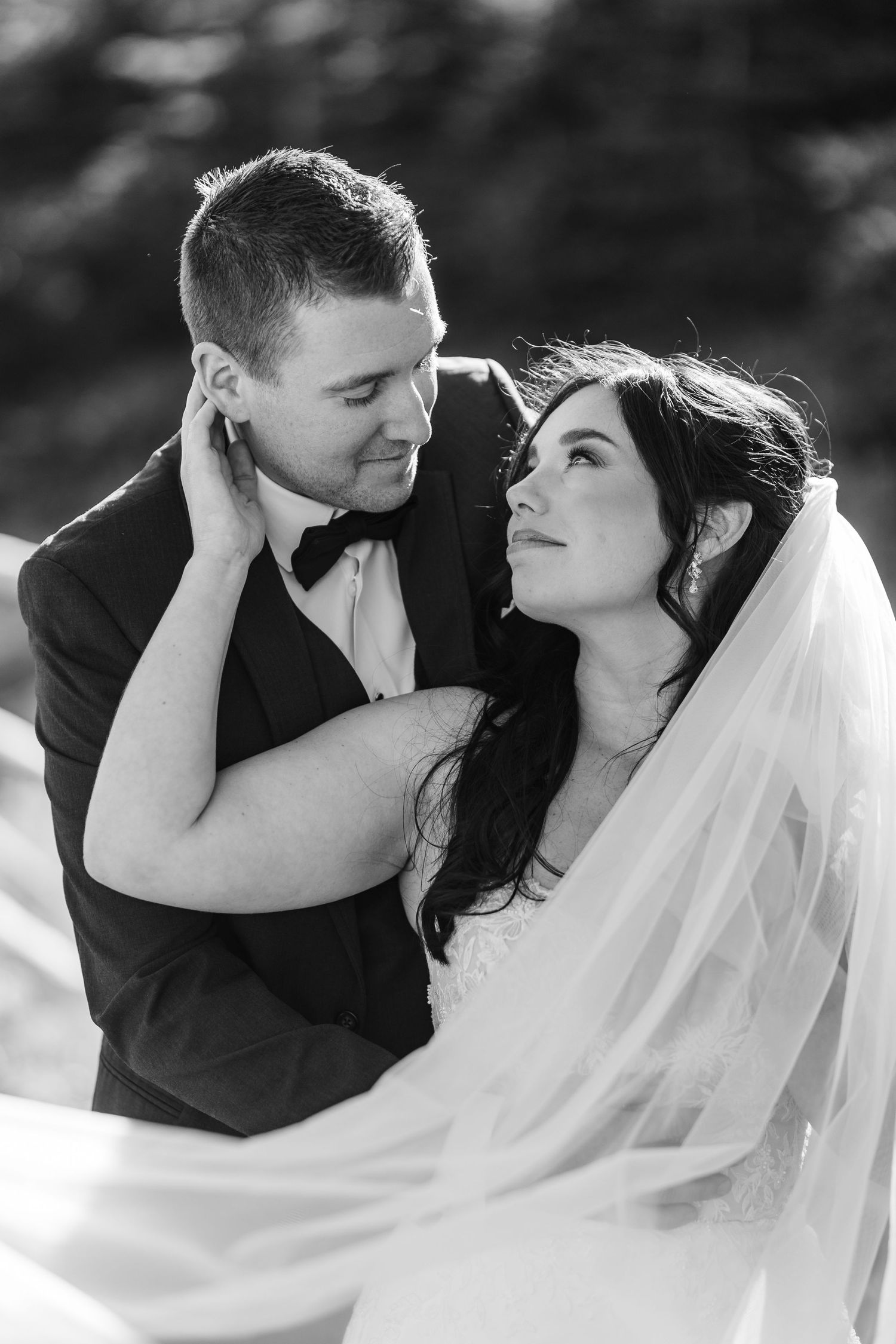 A romantic black and white photo sequence of a bride and groom embracing and sharing intimate moments on their wedding day.
