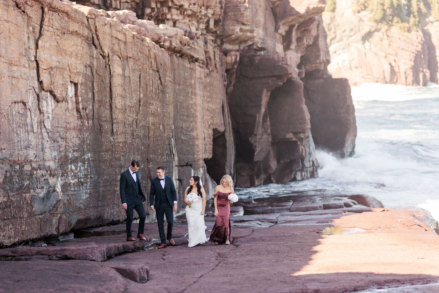 Tourists explore the scenic red rock canyon walls and sandy paths of Petra's ancient Siq passageway in Jordan.
