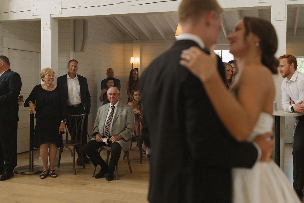 Wedding reception dancing in a bright modern chapel venue.
