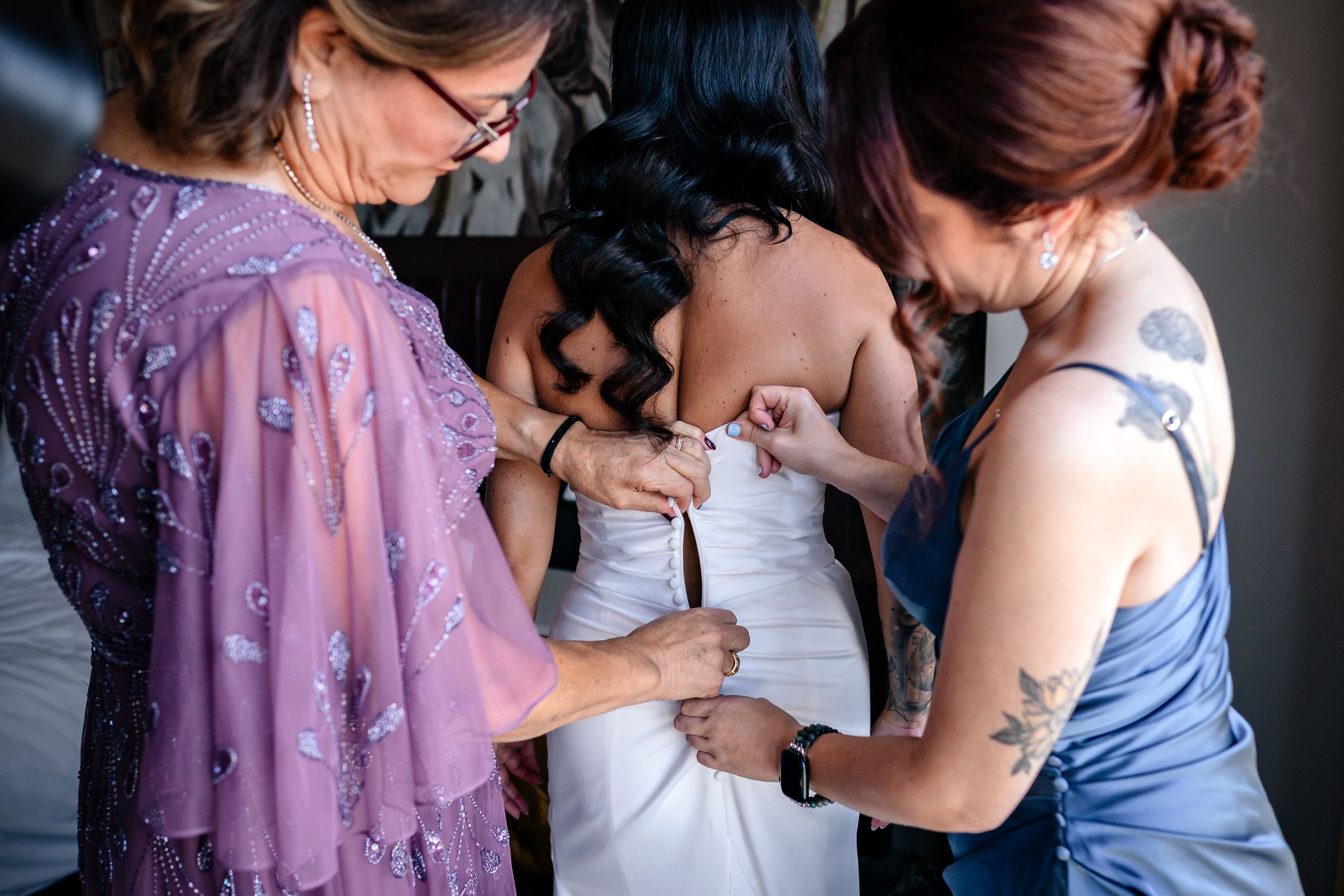 Wedding party members embracing and sharing emotional moments during preparation.