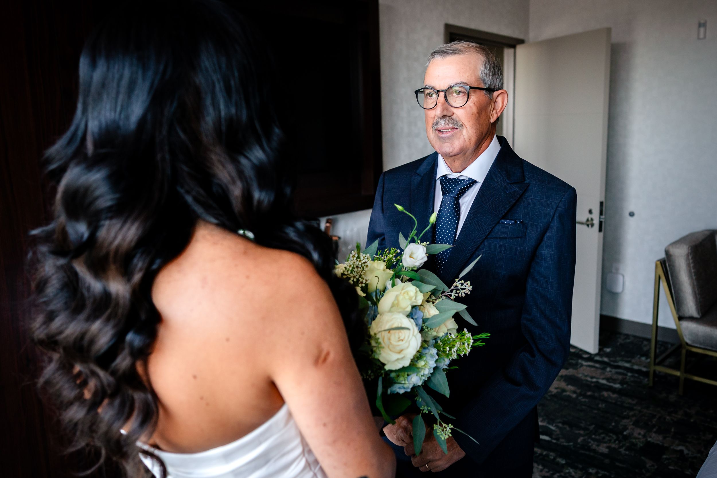 Final wedding preparations with bride and guests in formal attire.