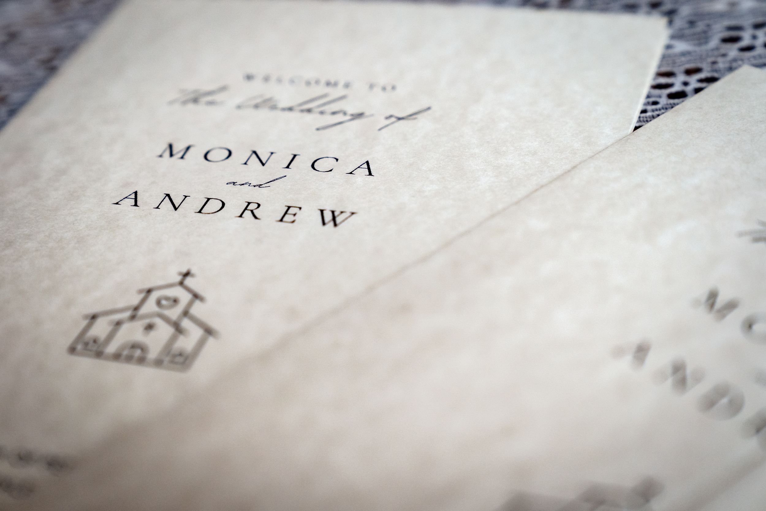 Close-up detail of elegant wedding invitation text printed on textured paper.