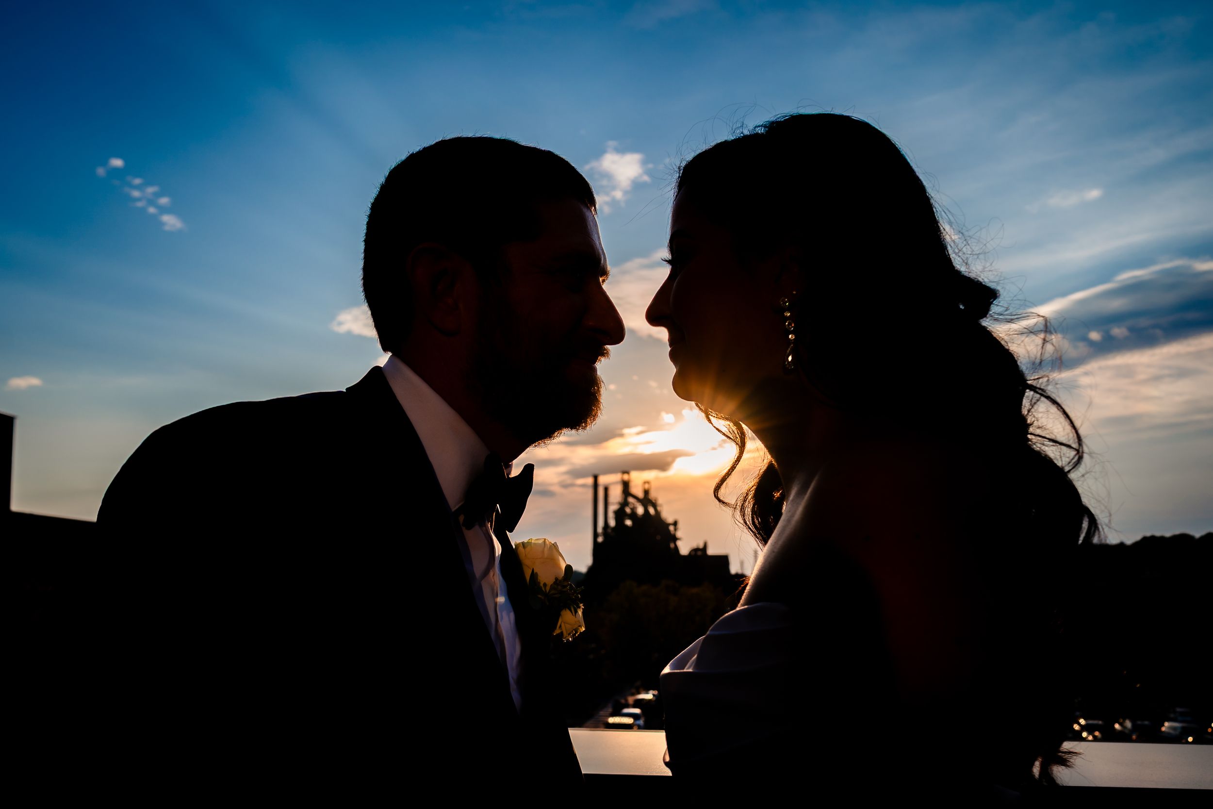 Silhouettes of a couple against a vibrant sunset sky.