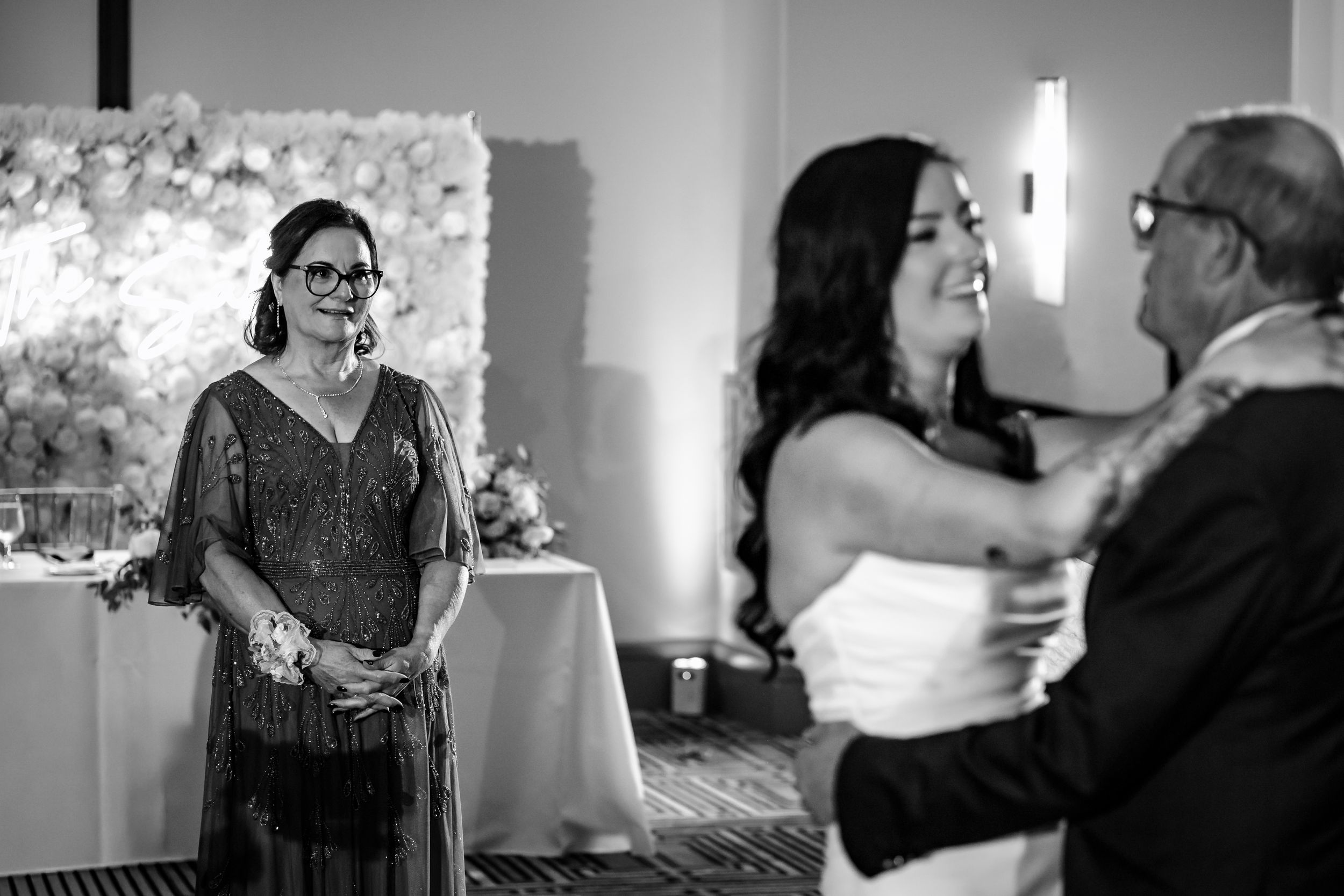 Black and white photos capture intimate dance moments during an elegant wedding reception.