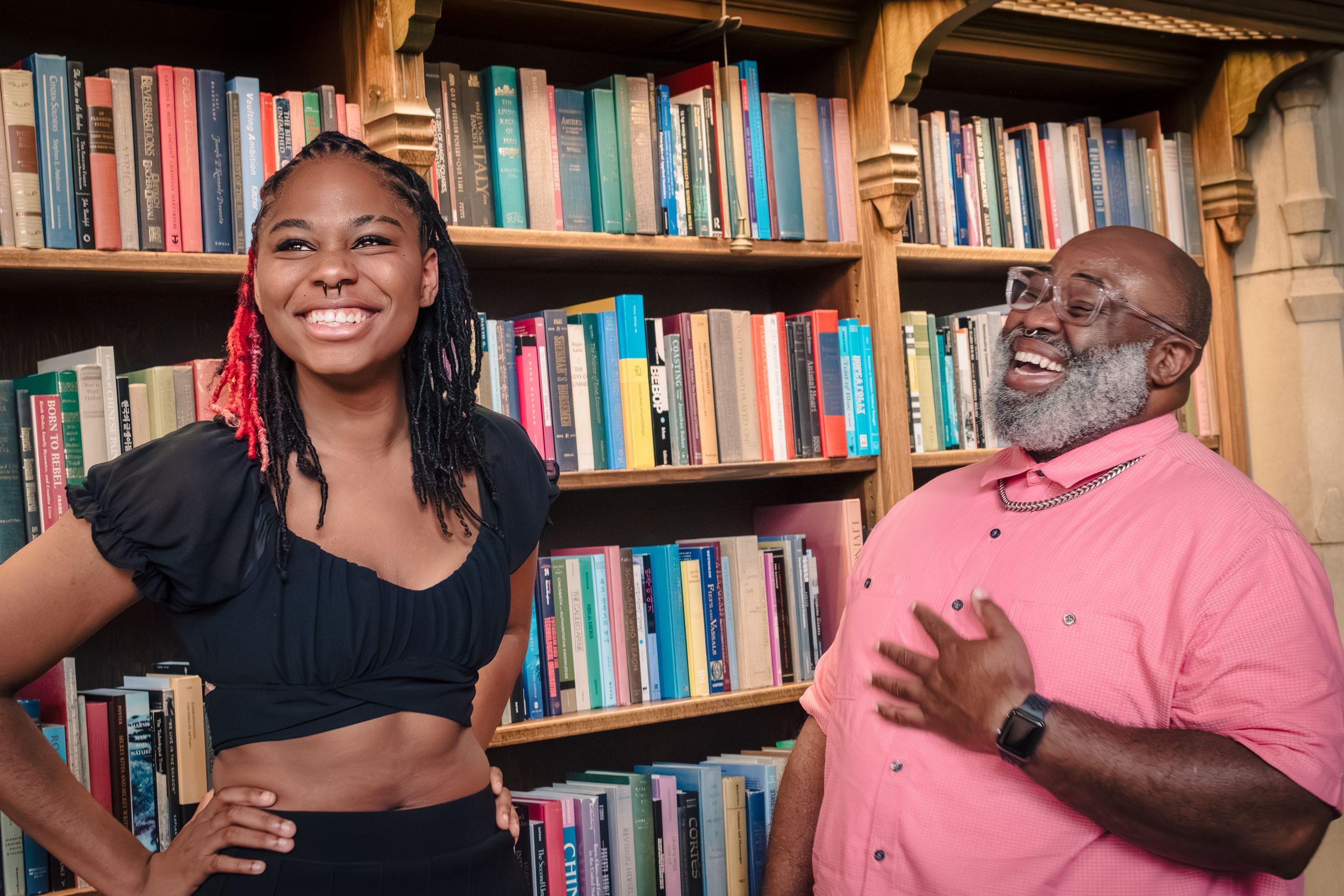 Candid senior laughing with her father in Suzzallo Library during Seattle senior photo session
