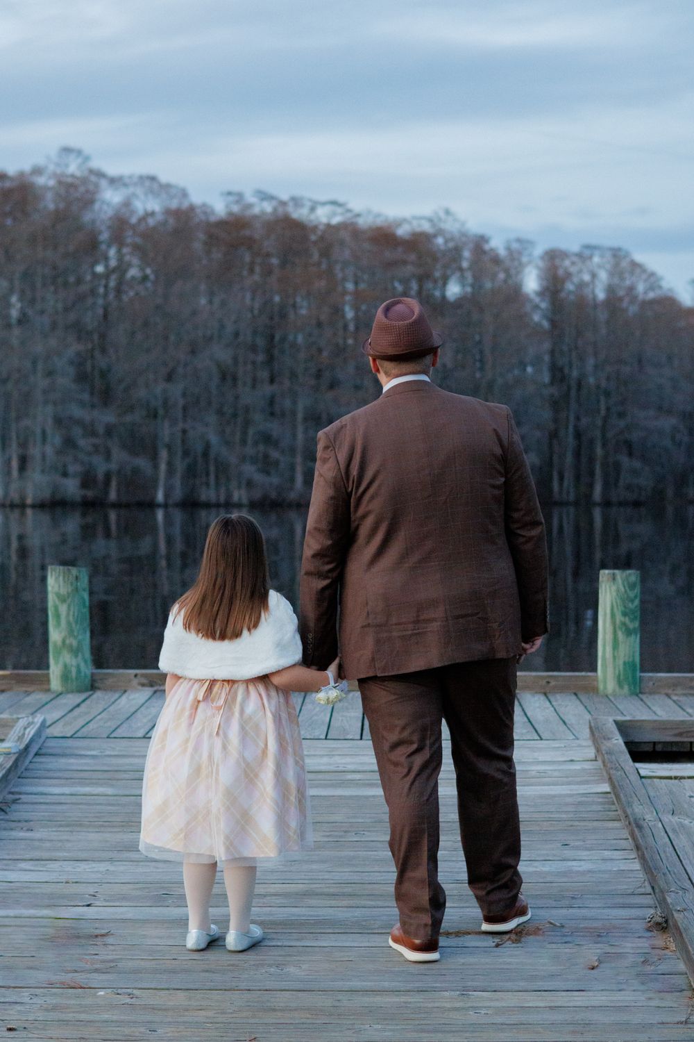 Father and daughter smiling together during sunset portrait session near Edenton waterfront