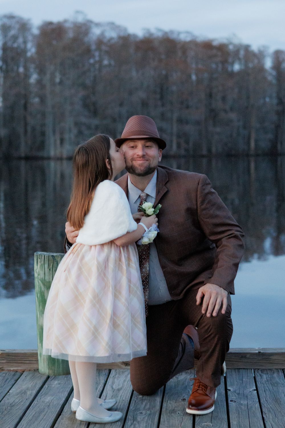 Father and daughter smiling together during sunset portrait session near Edenton waterfront