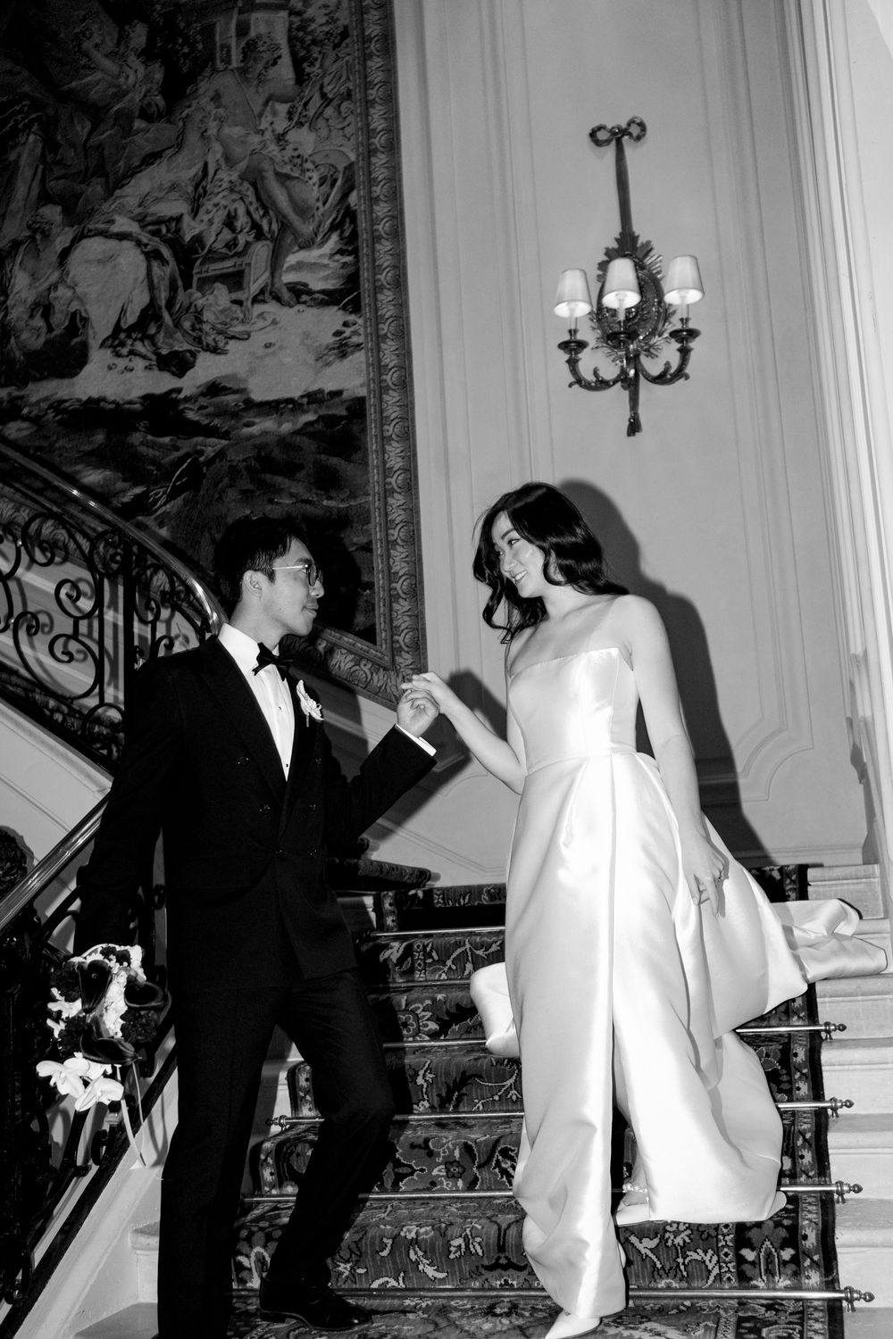 A sequence of black and white photographs showing a couple in formal attire walking together in an elegant interior space.
