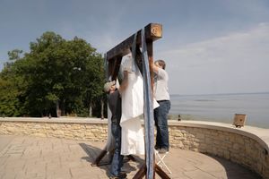 Wedding ceremony setup on stone overlook with scenic mountain views.