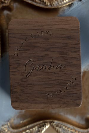 Wooden wedding keepsake with engraved date and names in cursive script.