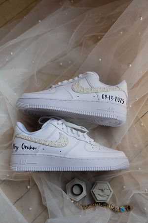 White Nike Air Force 1 sneakers decorated with crystals and custom text for a wedding.
