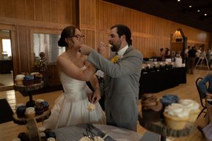 Wedding reception scene showing couple cutting their wedding cake together.