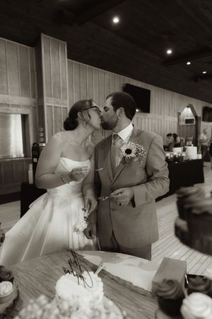 Intimate black and white reception moment of couple at their wedding table.