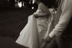 Artistic black and white detail shot of wedding dress movement.