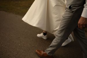 Close-up of wedding dress hem and dress shoes during dance.