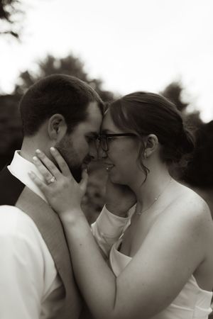 Intimate black and white portrait of romantic wedding moment.