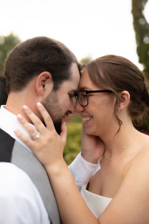 A tender wedding moment showing a close embrace and sparkly engagement ring.