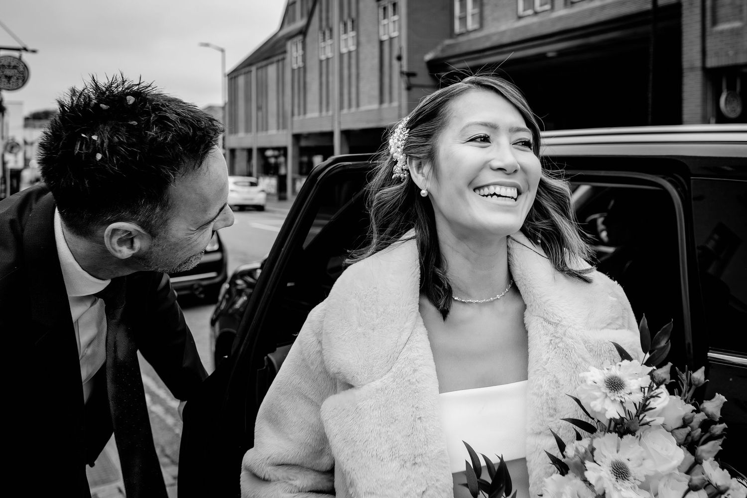 Black and white wedding photo collage showing intimate moments between newlyweds and guests during celebration.