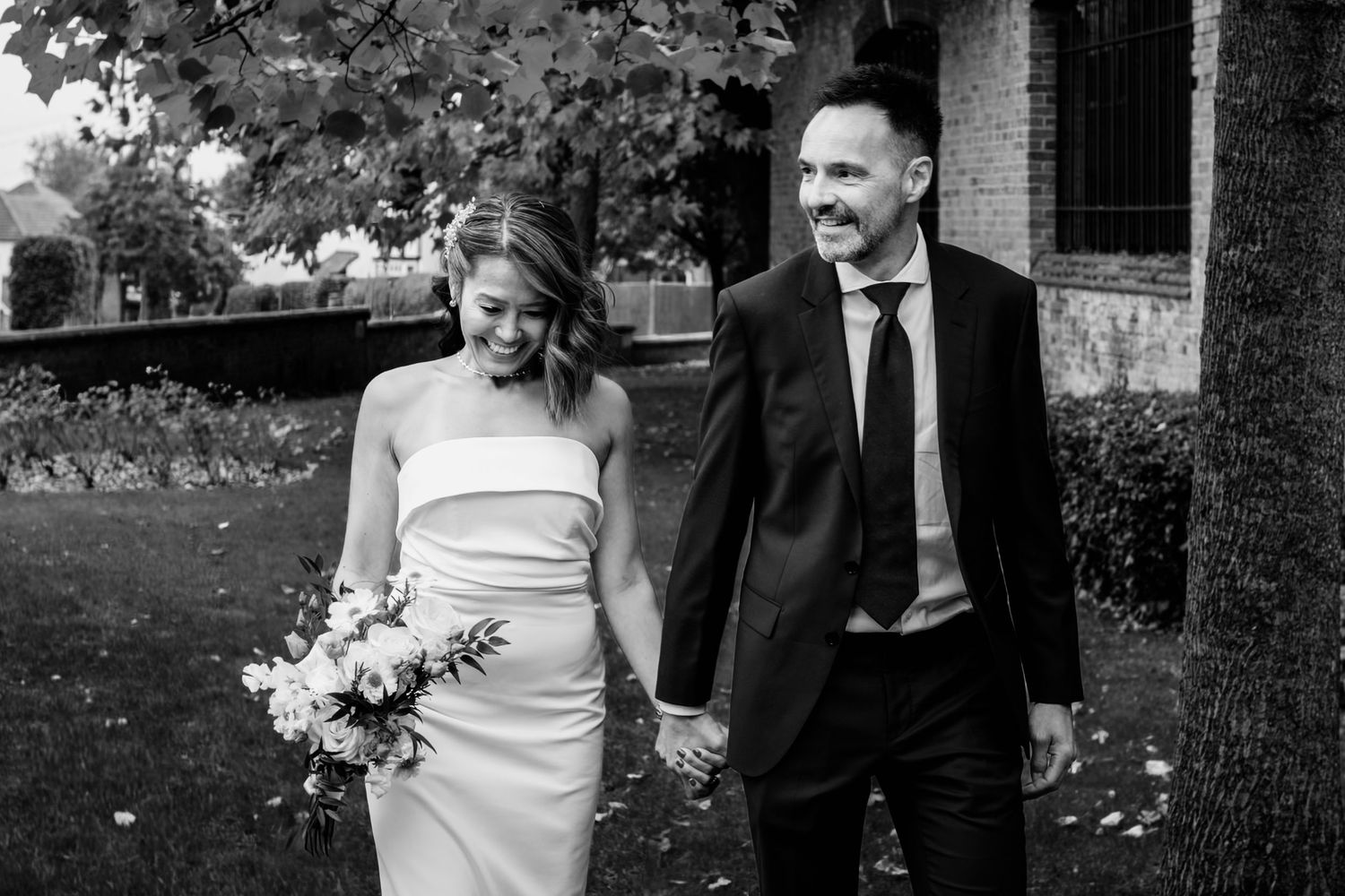 Bride and groom share an intimate moment outdoors during their wedding celebration.