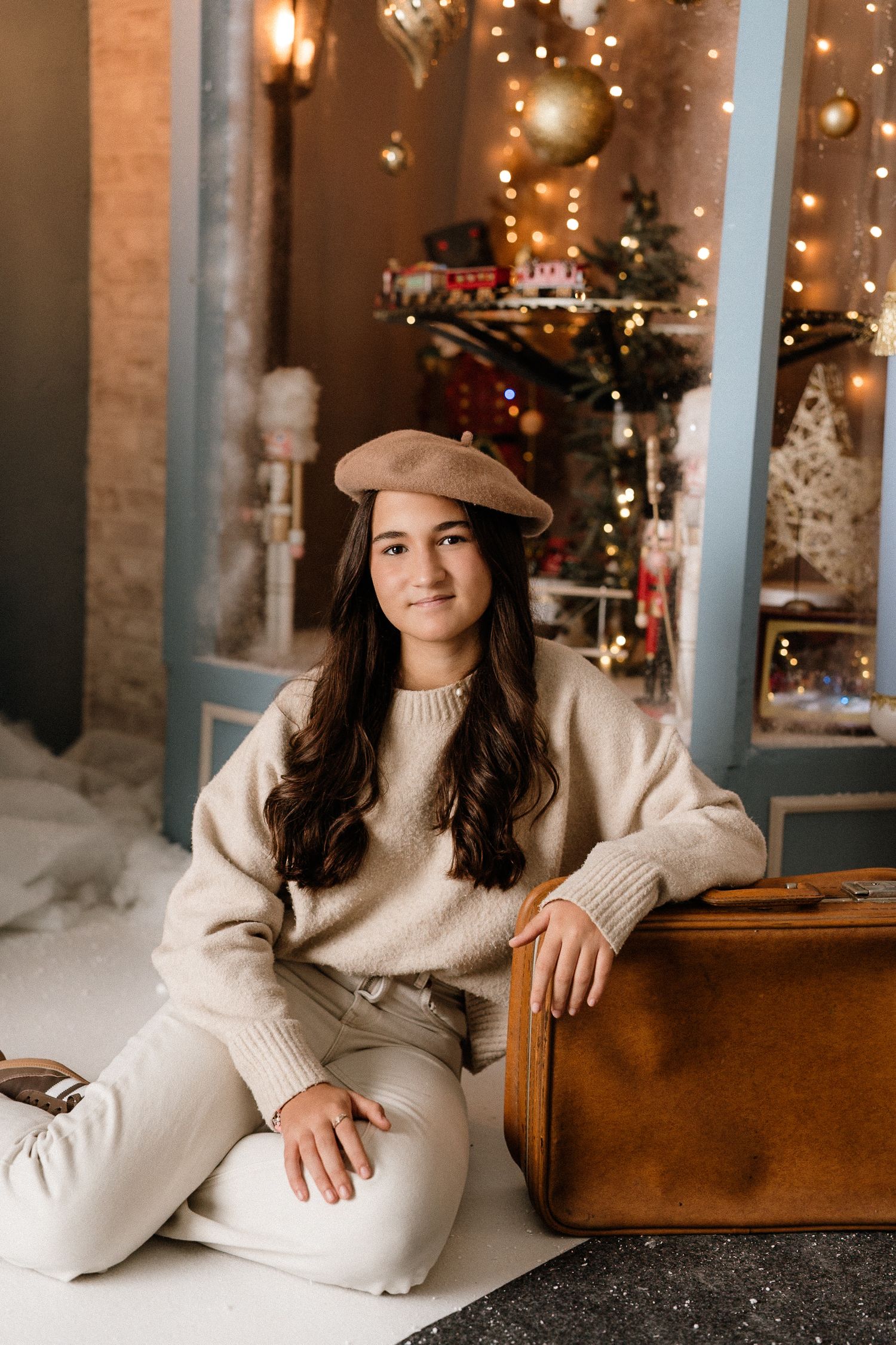 A couple relaxes together on a cozy floor near a decorated Christmas tree during the holiday season.