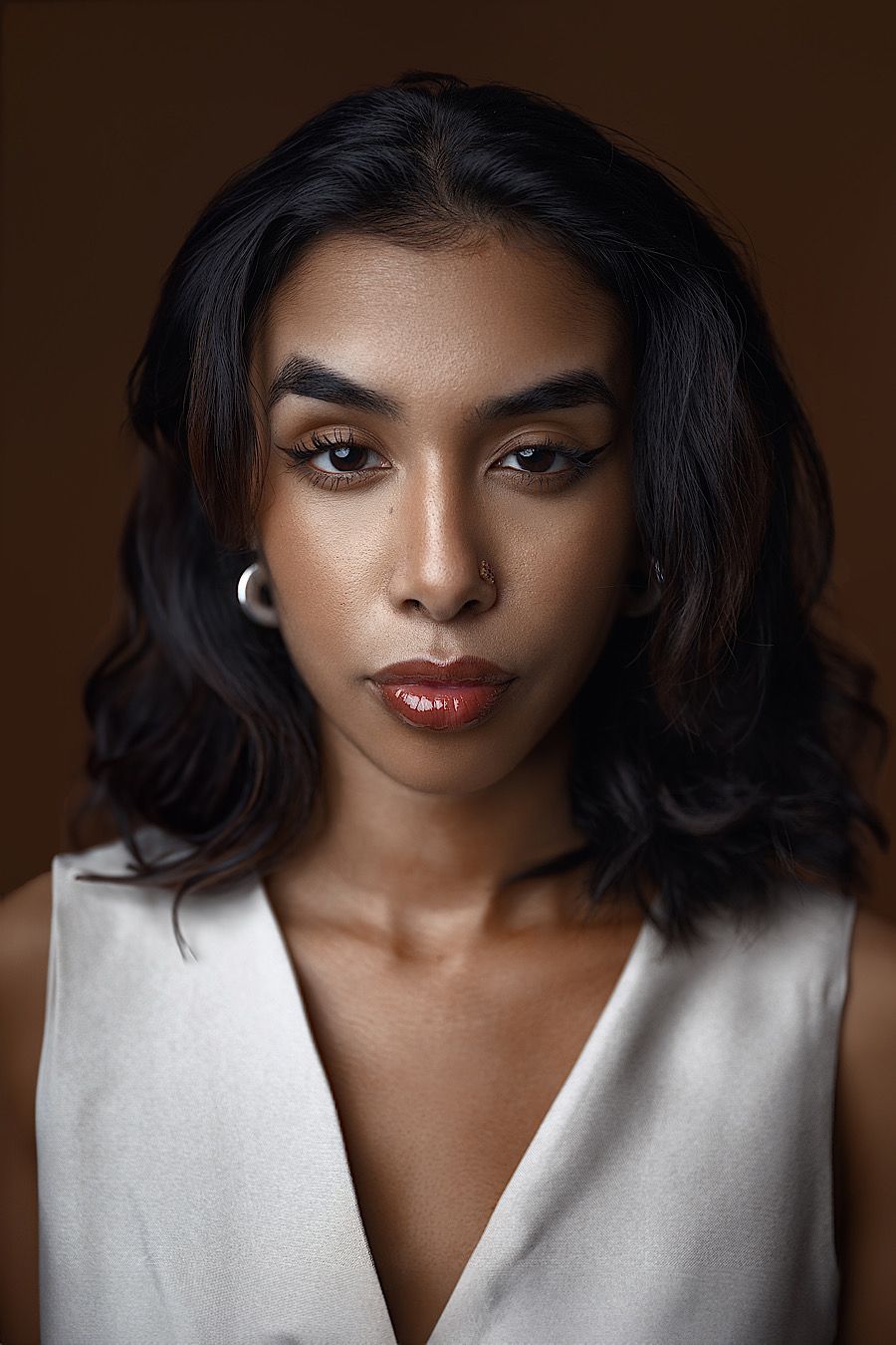 Soulful dimensional portrait by Boyd Visuals. Subject shows calm sincerity, quiet strength. Capturing authentic vulnerability. Studio photo.