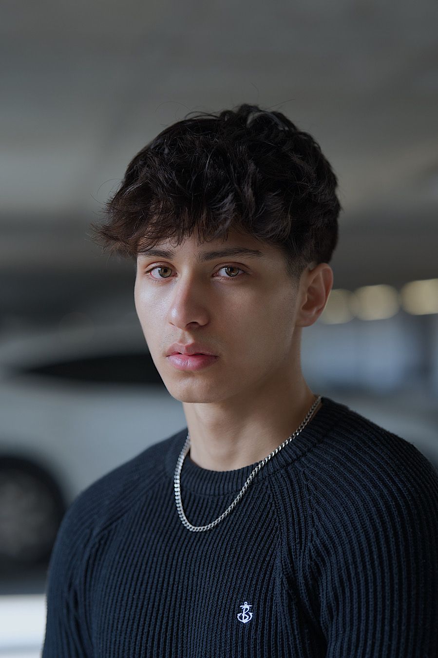 Urban portrait by Boyd Visuals, London. Subject's compelling gaze, modern setting. Capturing bold youthful confidence.