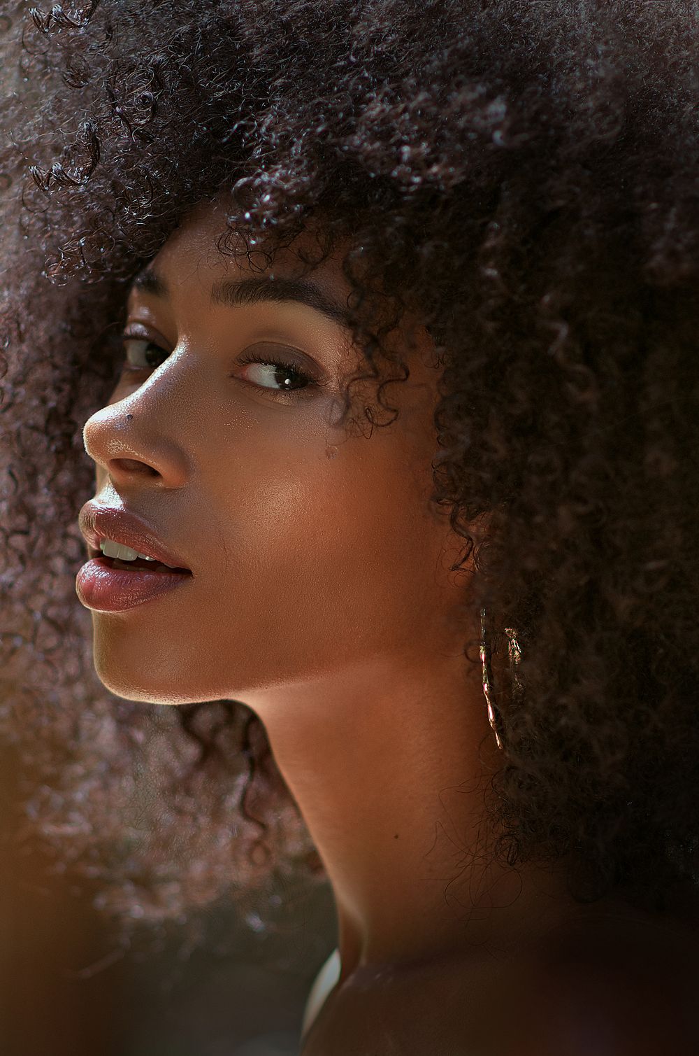 Soulful dimensional portrait by Boyd Visuals. The subject's side profile is beautifully lit, showing inner strength and natural beauty.