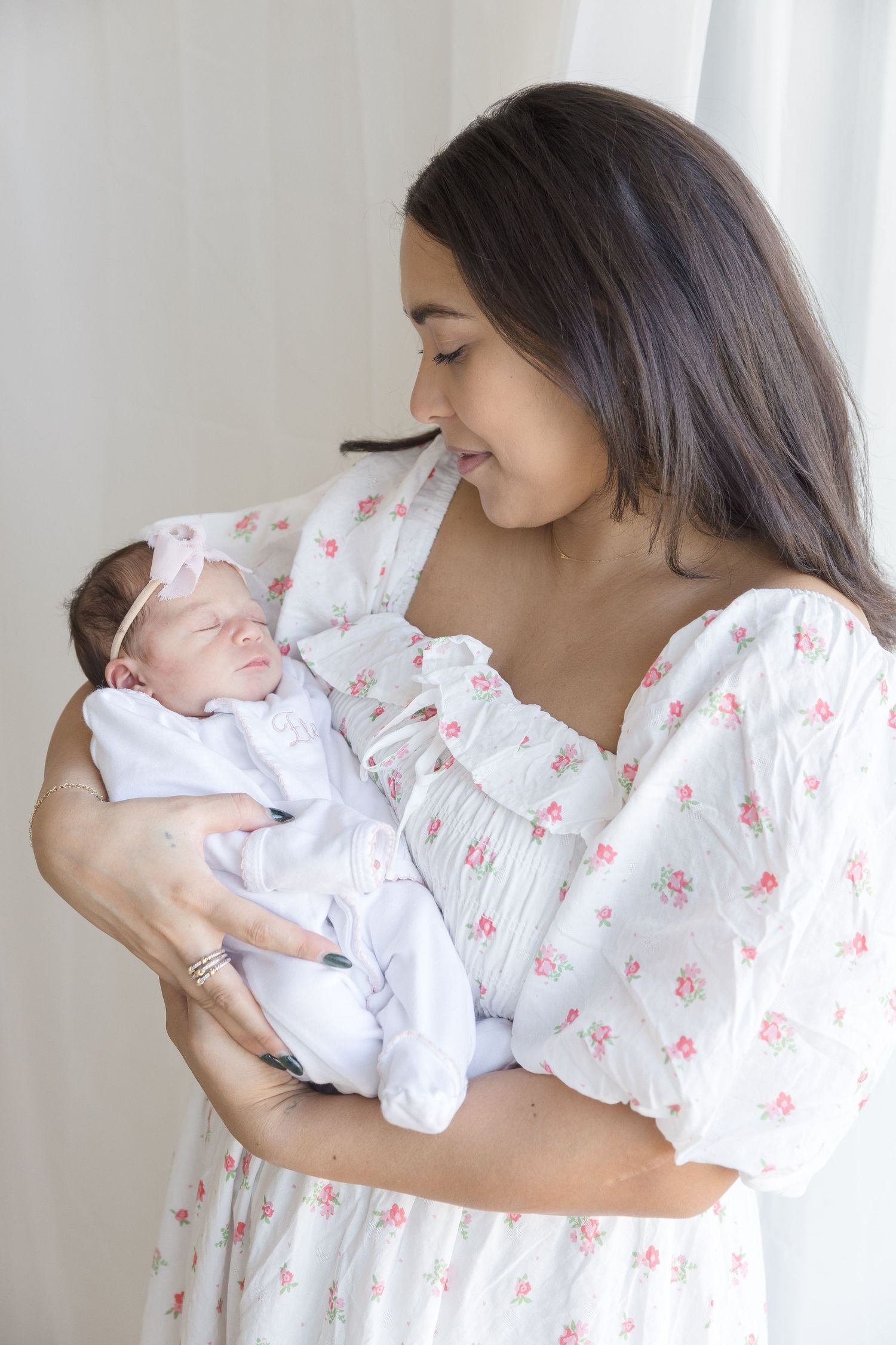 "Mother holding sleeping newborn in Washington DC luxury newborn session."
