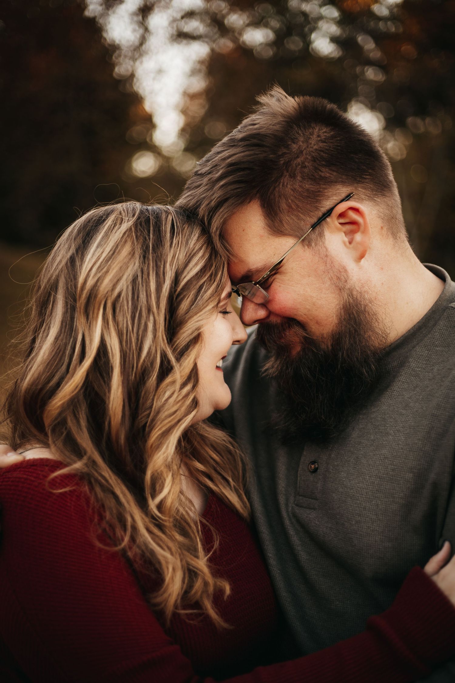 Jessica and Marc touching foreheads in a field located in Moneta, Virginia.