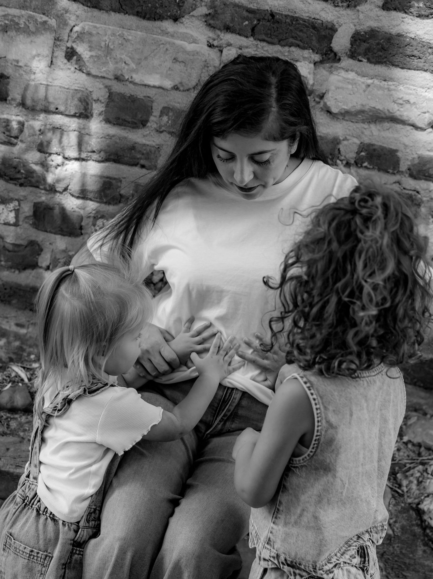 Intimate black and white photo sequence showing tender moments between parent and child.