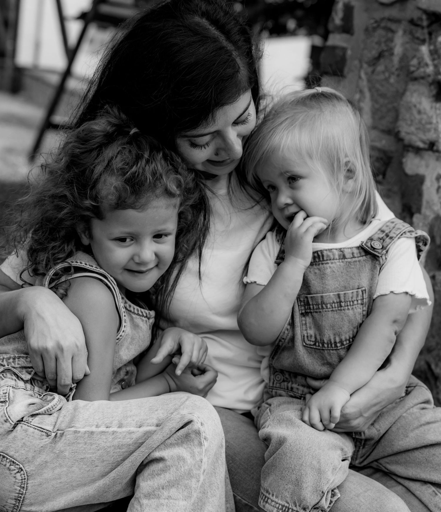 Intimate black and white photograph of family sharing a tender moment together.