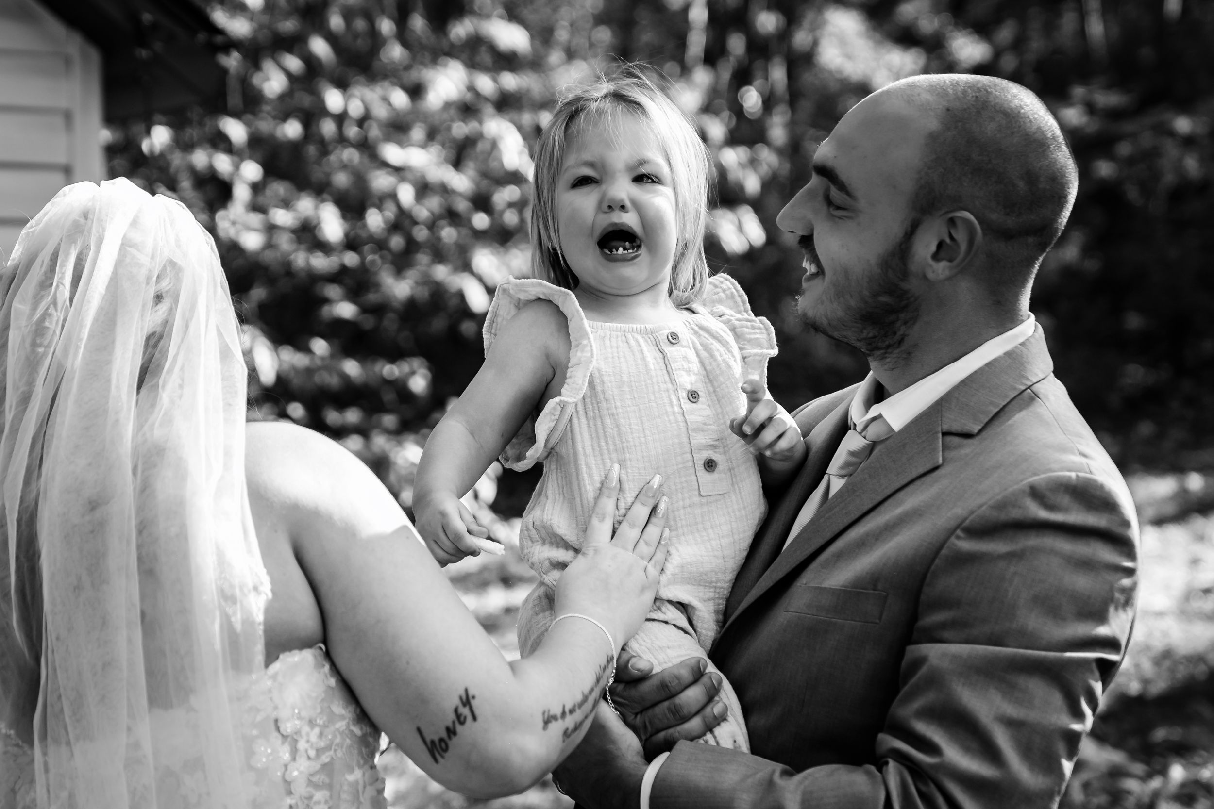 Candid emotional moments captured between couple during their outdoor wedding celebration.