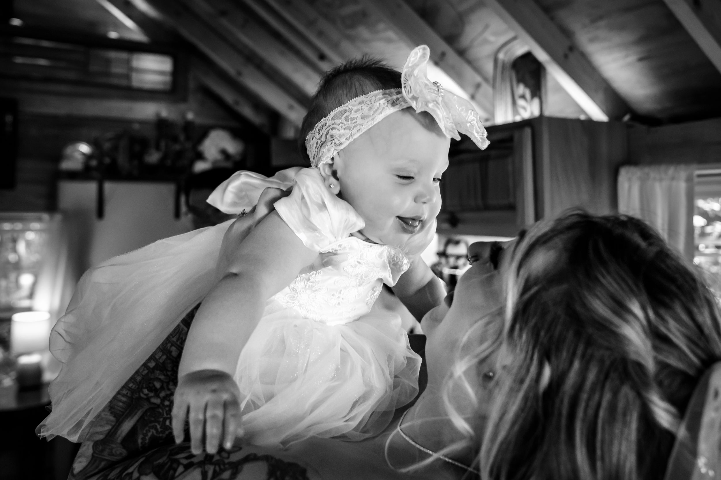 Black and white intimate wedding moments captured indoors during reception celebrations.