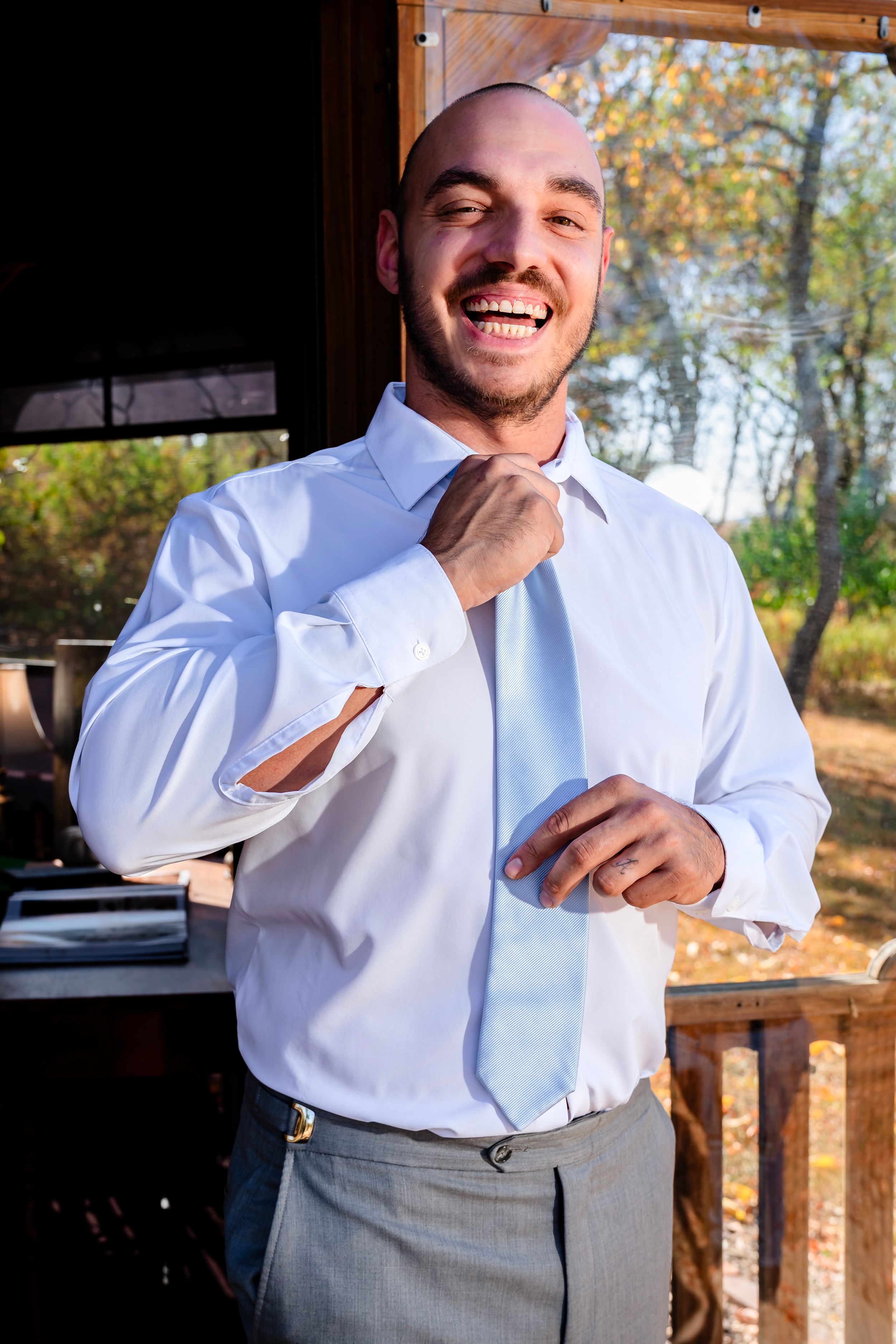 A joyful moment captured during wedding preparations in natural lighting.