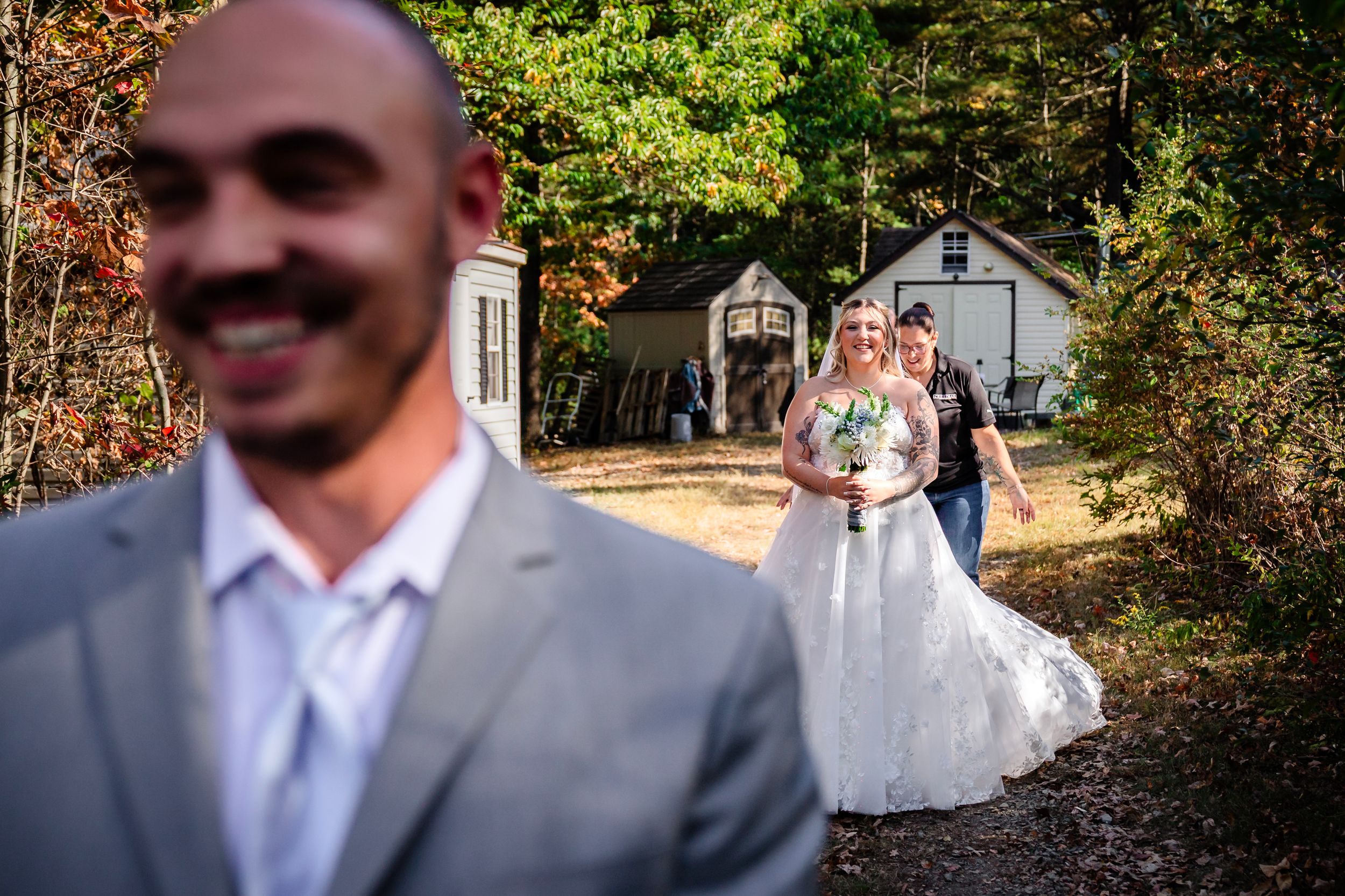 Candid wedding moments captured in outdoor forest setting during autumn.