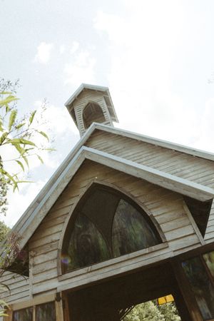 A white wooden architectural detail shows four sequential views of an arched gable or dormer window on a house exterior.