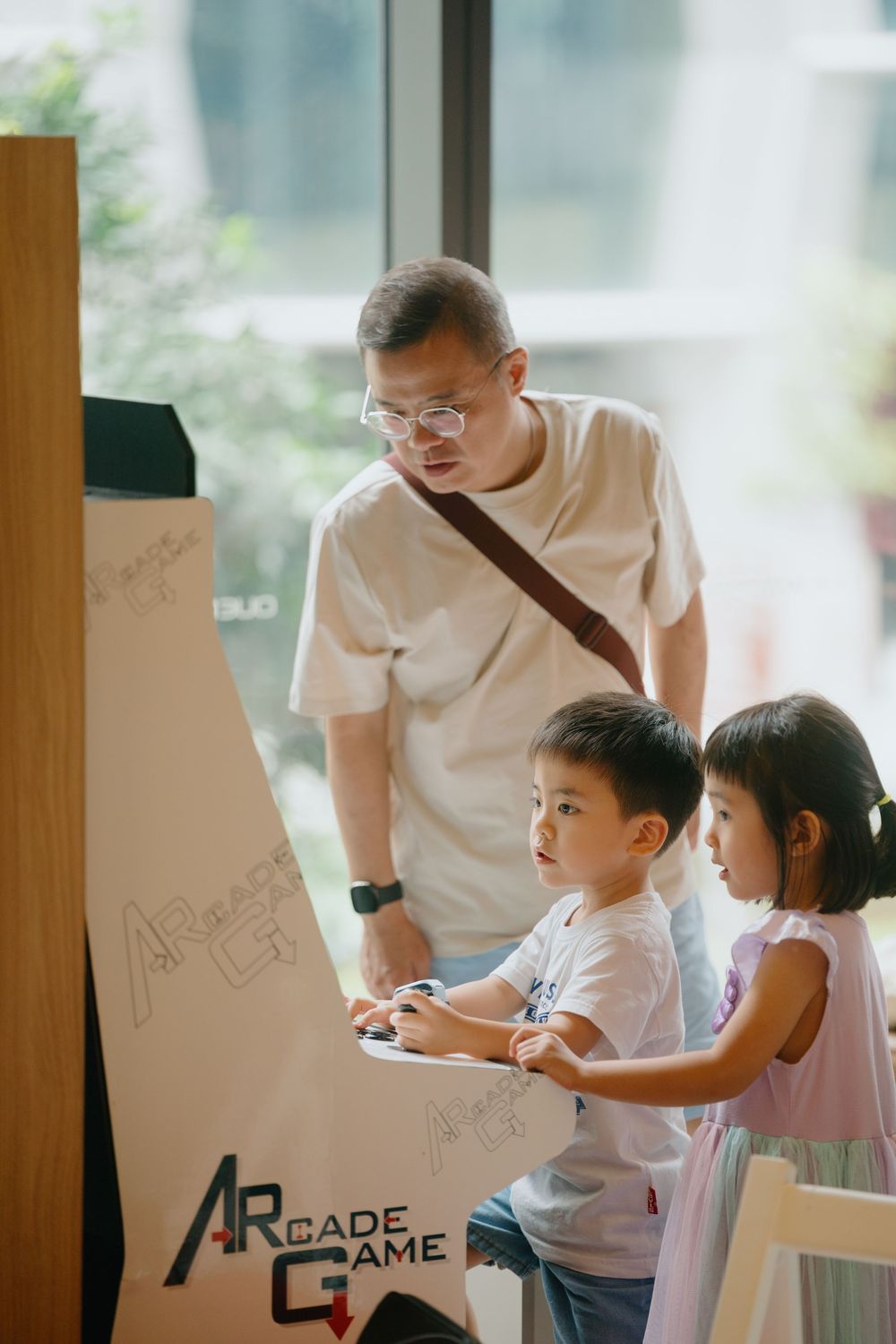 Students gather around a whiteboard during an interactive learning session in a bright classroom setting.