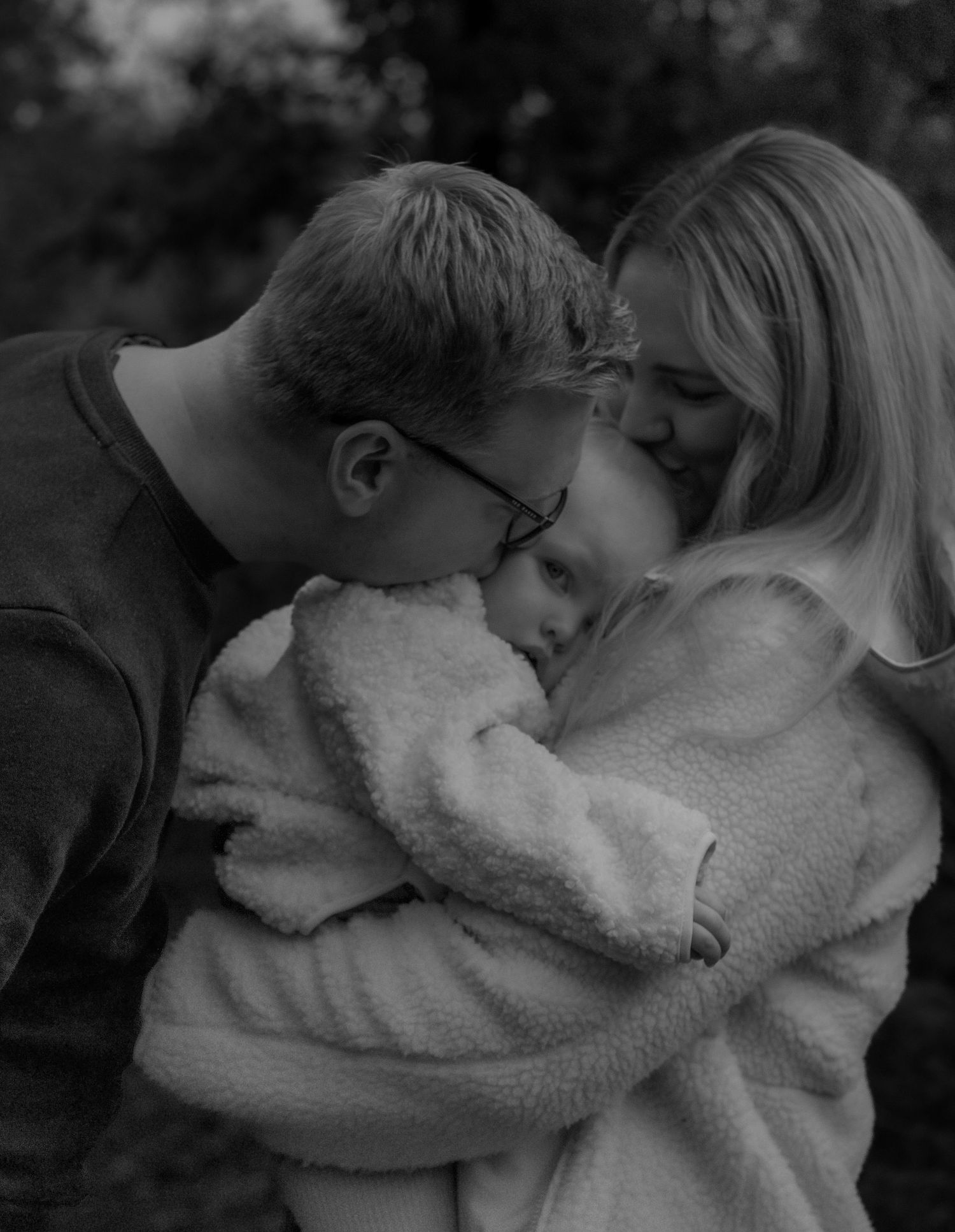 Natural family portrait surrounded by fallen leaves during lifestyle photography session in Derbyshire and beyond.