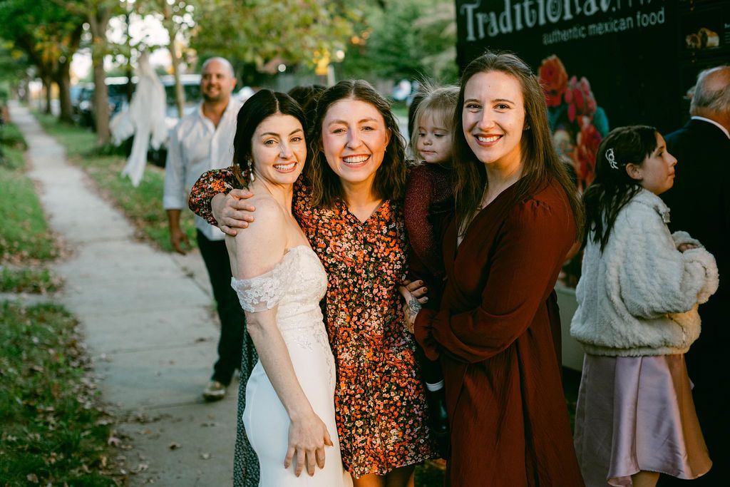 A group of friends walking together on a sidewalk in autumn wearing casual outfits.