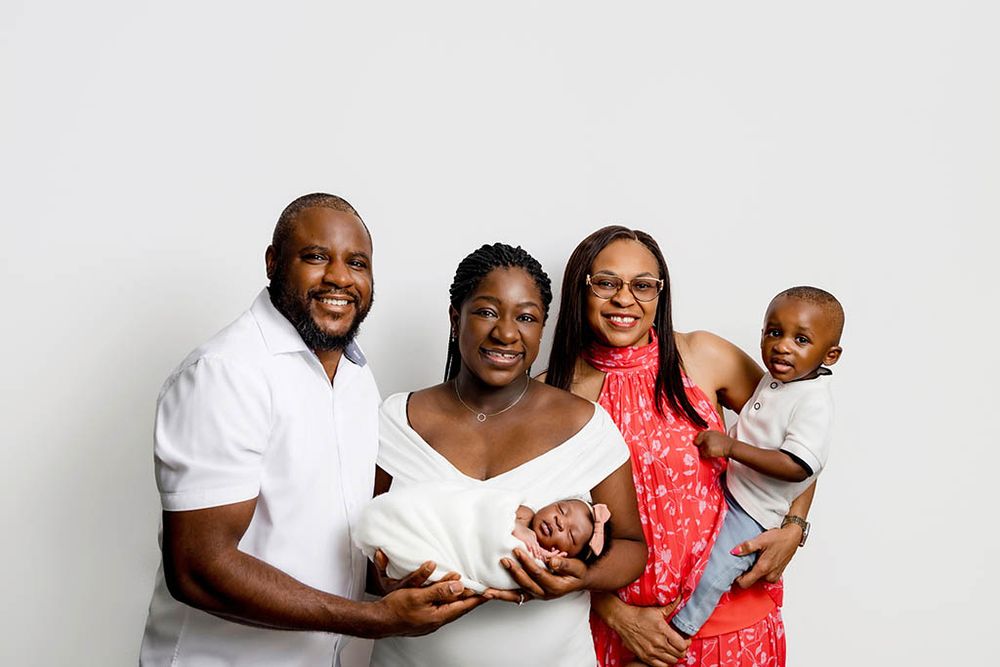 Parents, grandmother, big brother and newborn baby sister in family portrait in Hemet.