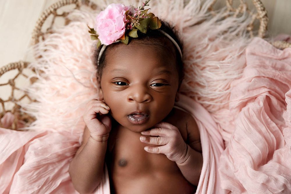 Newborn baby girl sleeping in professional studio portrait by Hemet photographer.