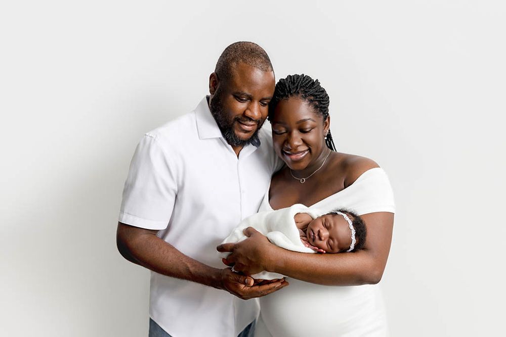 Parents and newborn baby girl photoshoot by professional newborn photographer in Hemet, California.