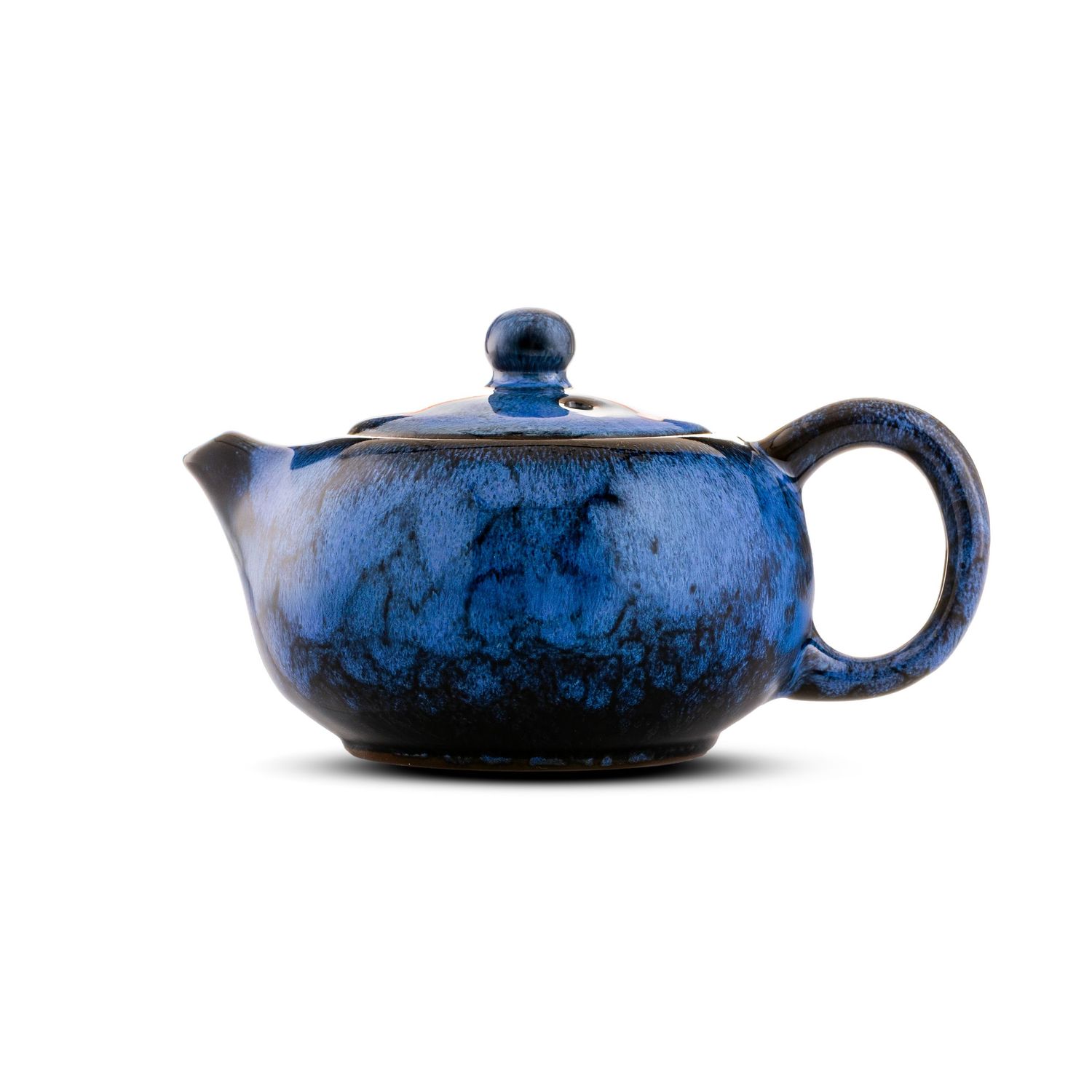 Blue ceramic teapot with marbled glaze pattern, round lid with knob, curved spout and handle on white background.