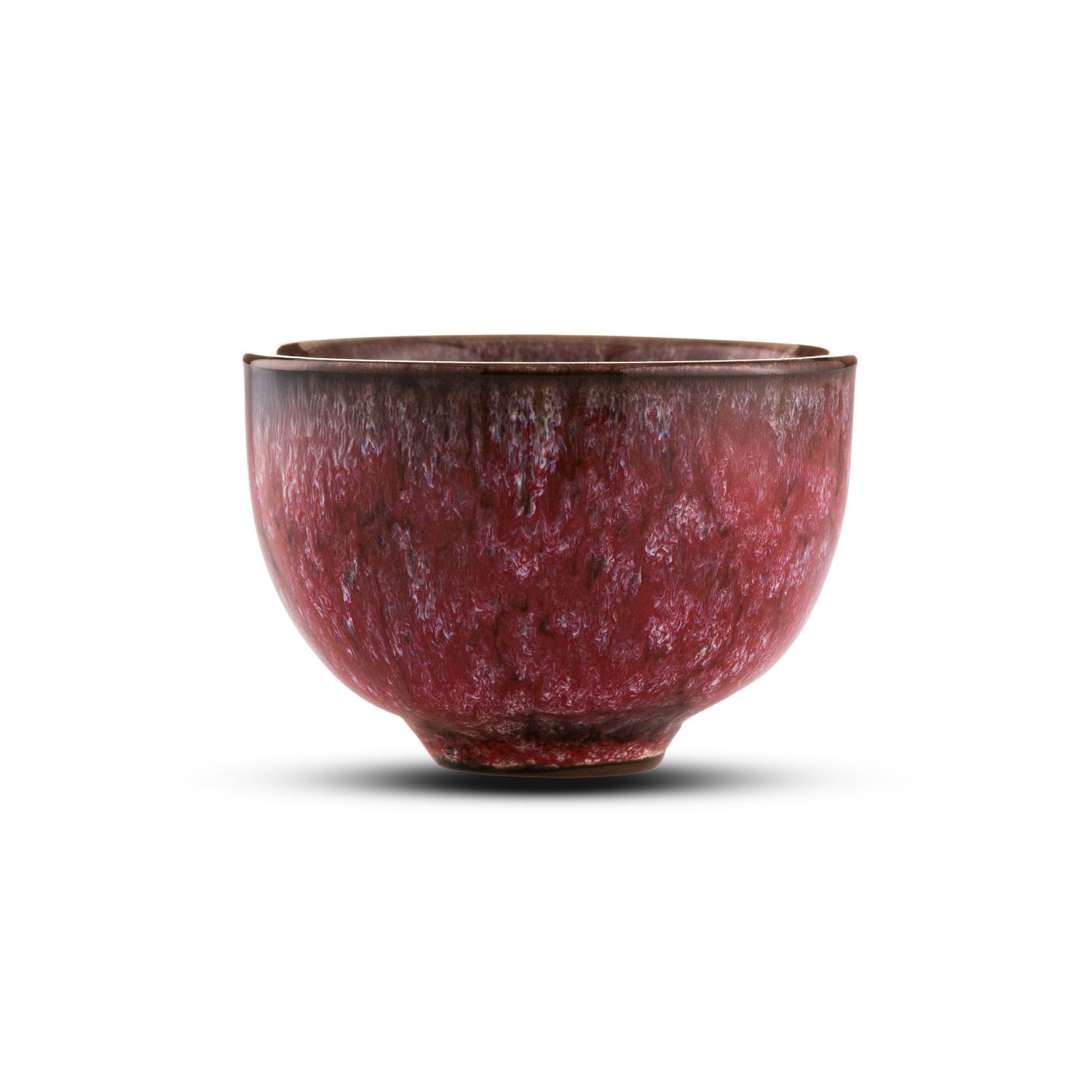 Deep crimson red ceramic tea bowl with mottled glaze finish, handcrafted pottery cup with rich burgundy tones.