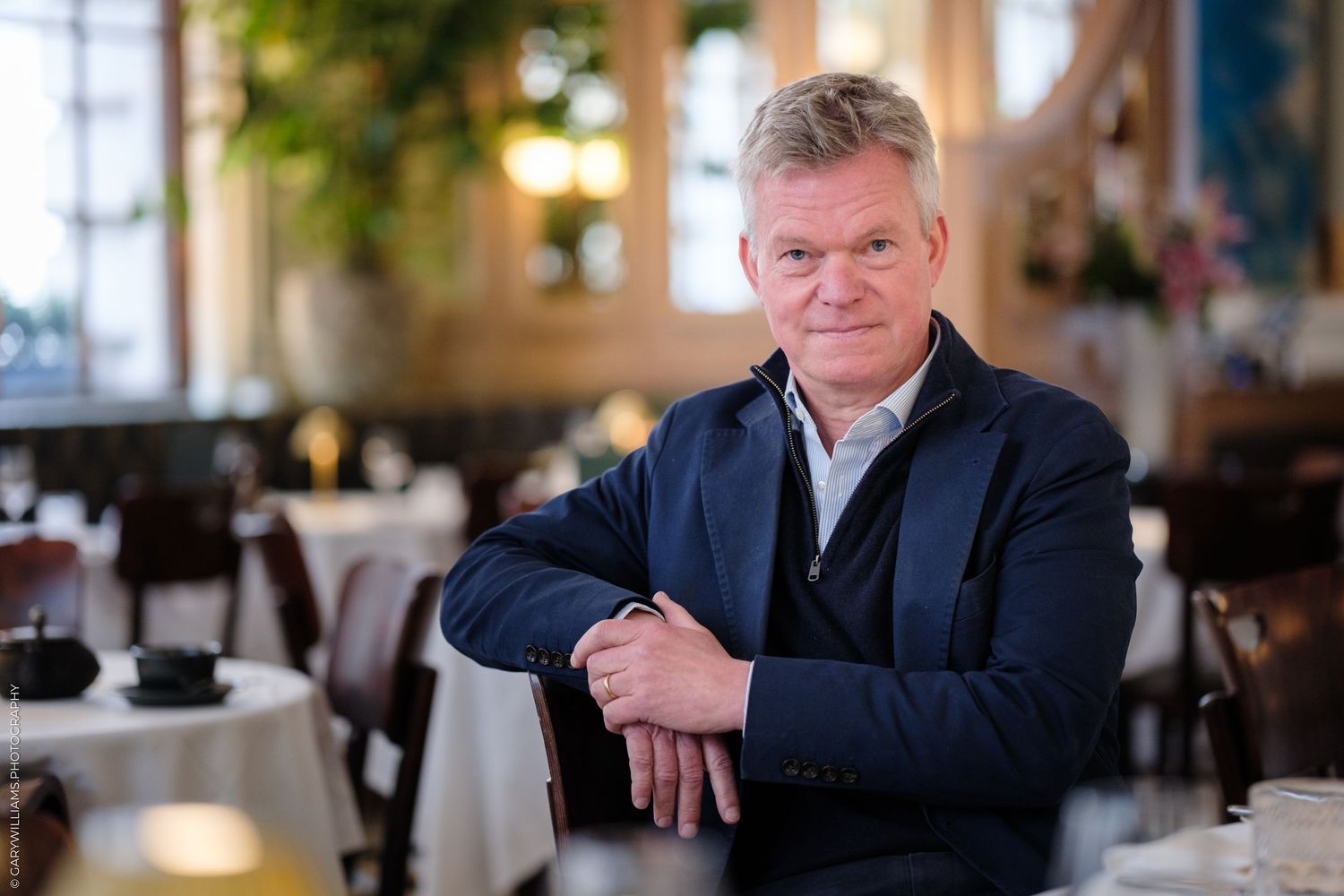 Soren Jessen of 1 Lombard Street poses in a blue blazer in his restaurant